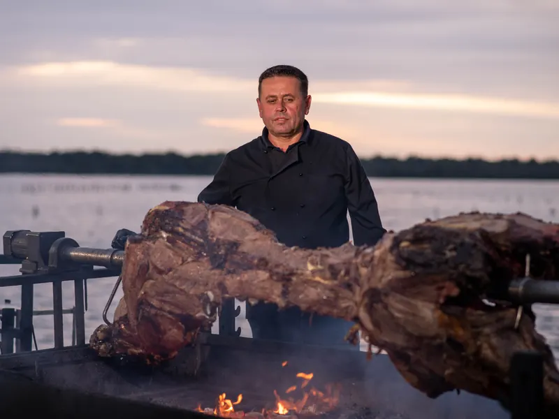 Spit roast at sunset by the lake