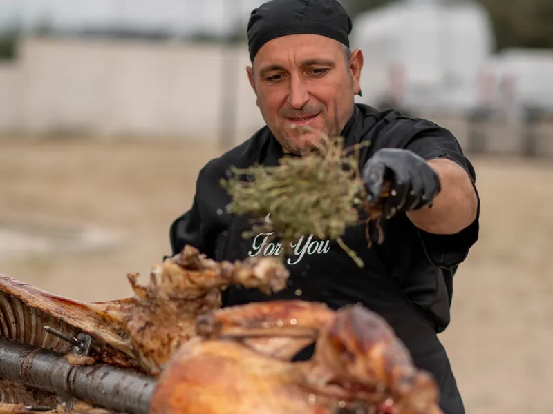 Whole turkey on the spit, basted with thyme